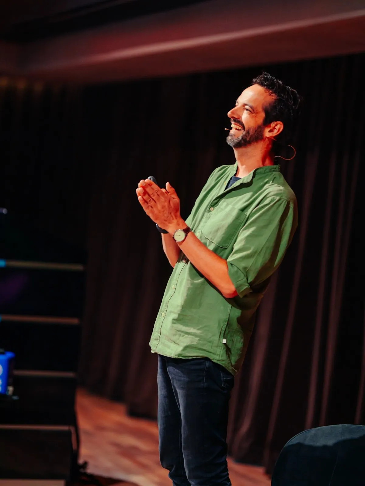 Mike laughing on stage during a presentation
